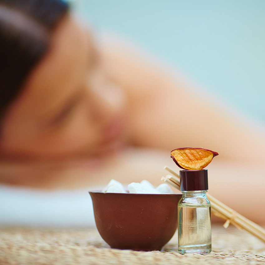 Natural spa soaps, herbs and towels on wooden tray